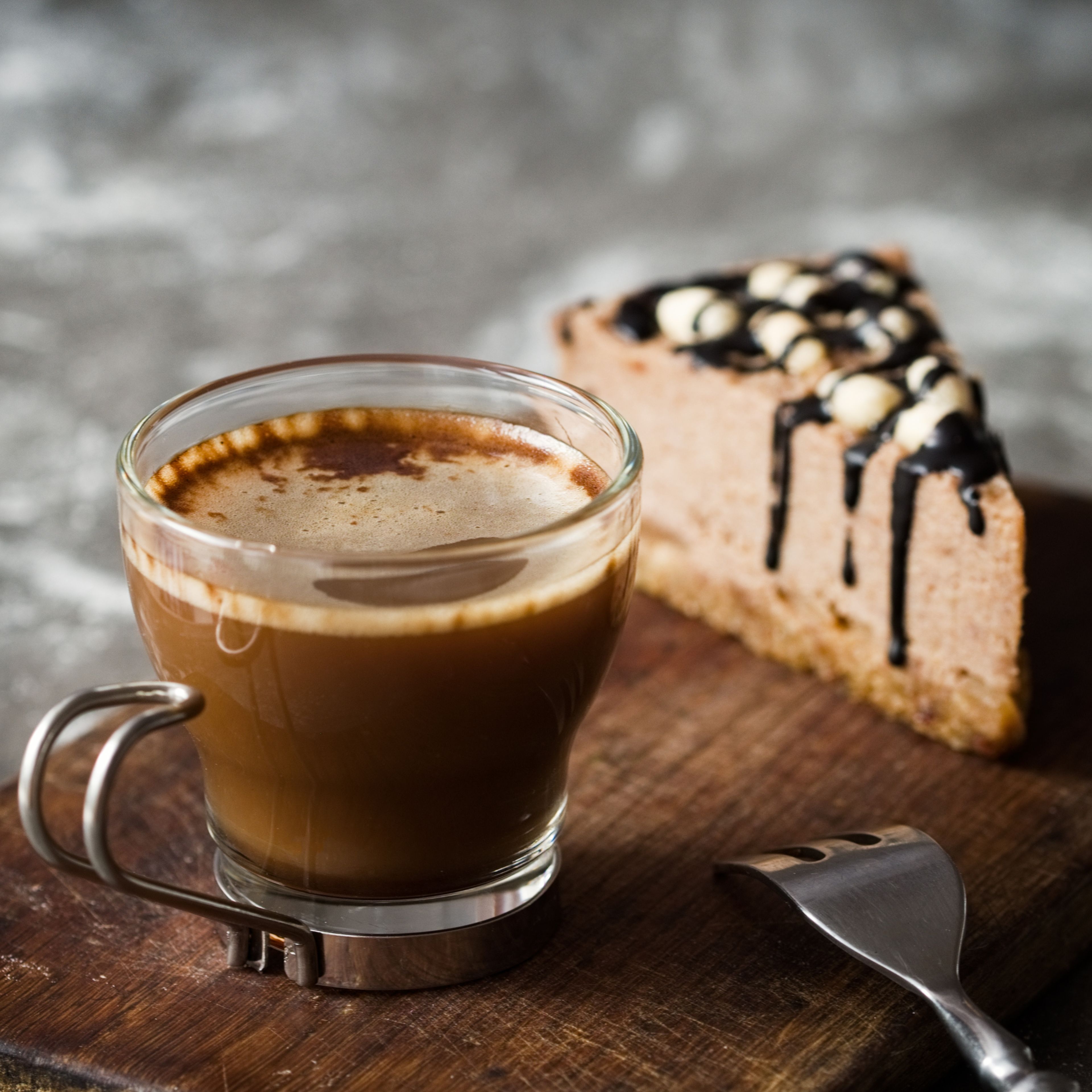 cup of coffee with a slice of cake